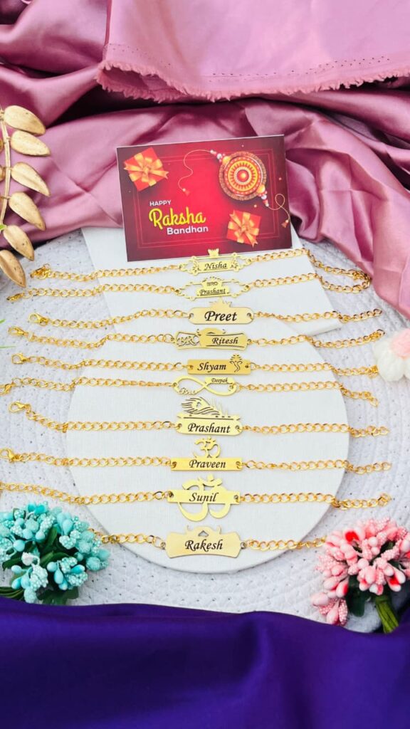 Custom gold name chain Rakhi bracelet with engraved name and adjustable stainless steel chain.