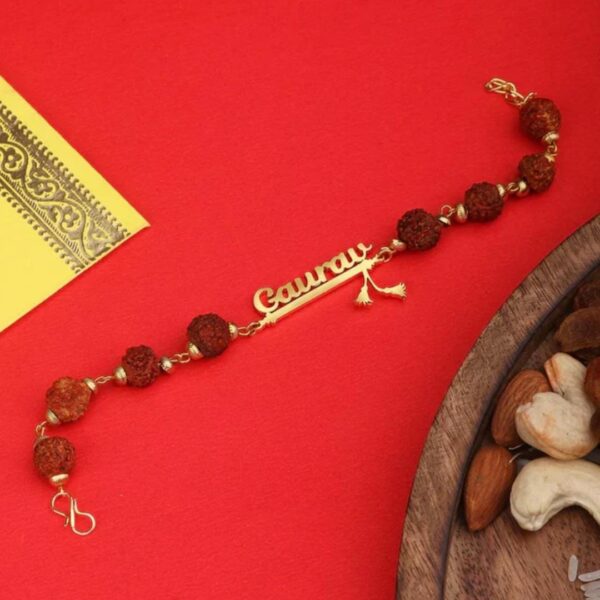 Customized Rudraksha name Rakhi bracelet with natural Rudraksha beads, gold-finish engraved name plate, and adjustable chain.