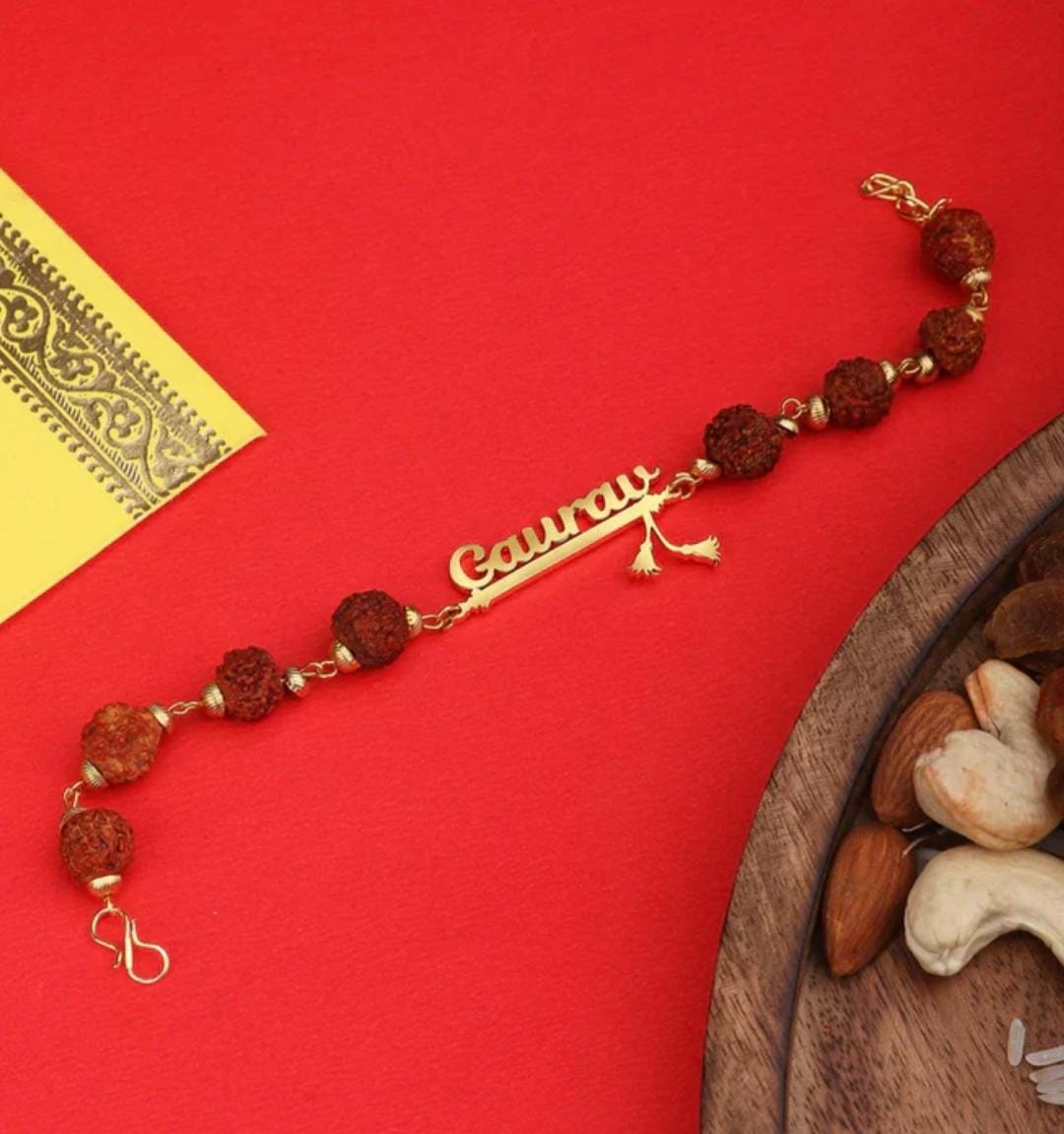 Custom Rudraksha Name Rakhi Bracelet Customized Rudraksha name Rakhi bracelet with natural Rudraksha beads, gold-finish engraved name plate, and adjustable chain.