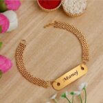Luxury gold-finish name bracelet Rakhi featuring an engraved metal plate and premium adjustable chain for Raksha Bandhan.