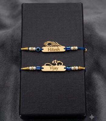 Customized gold name Rakhi with evil eye beads, pearl accents, silk thread, and engraved stainless steel name plate.