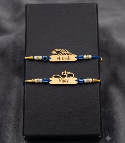 Customized gold name Rakhi with evil eye beads, pearl accents, silk thread, and engraved stainless steel name plate.