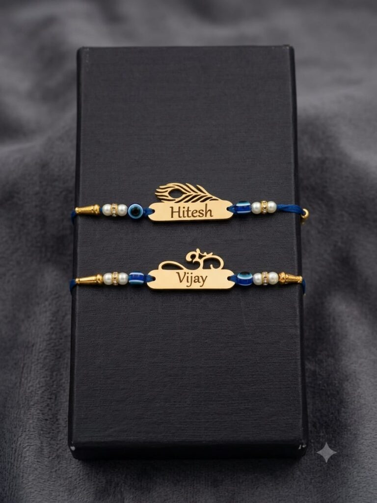Customized gold name Rakhi with evil eye beads, pearl accents, silk thread, and engraved stainless steel name plate.