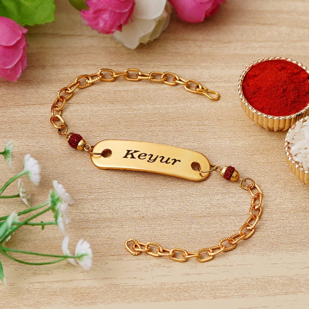 Custom gold name bracelet Rakhi with Rudraksha beads, engraved name plate, and premium adjustable chain.