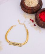 Gold turbo chain Rakhi bracelet featuring a custom engraved name plate with adjustable secure fit.