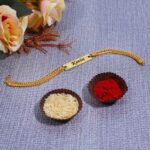 Elegant gold snake chain Rakhi bracelet featuring a personalized engraved name plate for brothers.