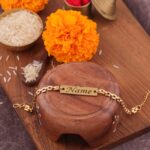 Elegant gold Sleek Chain Rakhi bracelet featuring a personalized engraved name plate for brothers.
