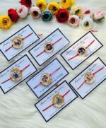 Personalized resin photo Rakhi with a custom picture, gold foil accents, and traditional red thread for Raksha Bandhan.