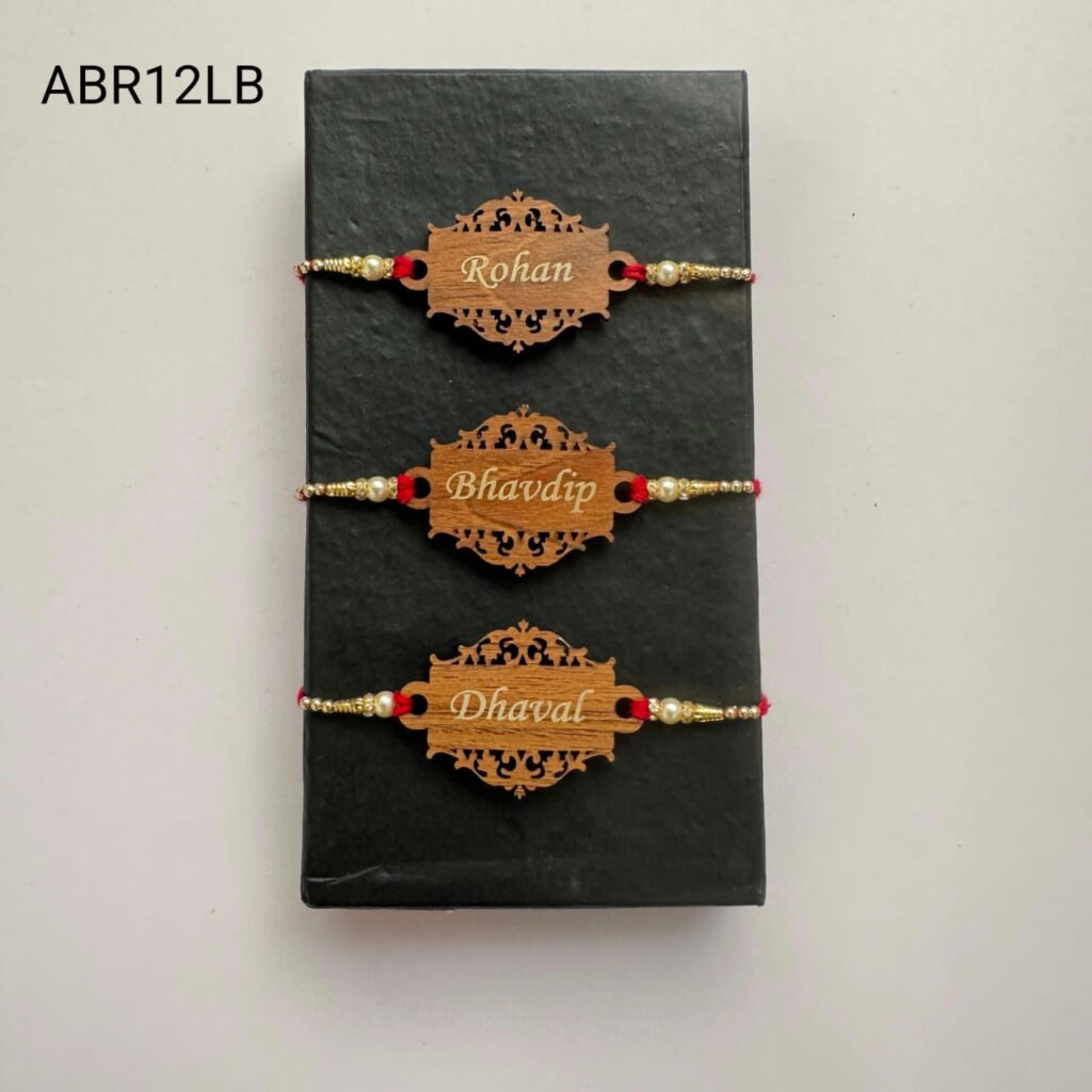 Personalized designer wooden name Rakhi with intricate laser-cut design, pearl bead accents, and traditional red thread for Raksha Bandhan.