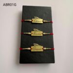 Personalized feather name plate Rakhi available in gold and silver finish with custom engraving, pearl beads, and traditional red thread.